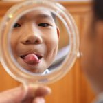 boy looking at himself in the mirror