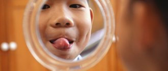 boy looking at himself in the mirror