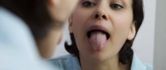 Woman examining tongue